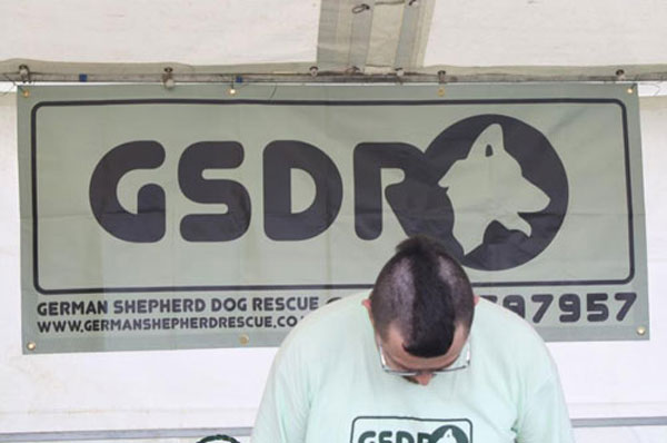 volunteer with half his head shaved