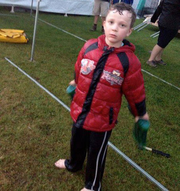 little boy wet through because of the rain