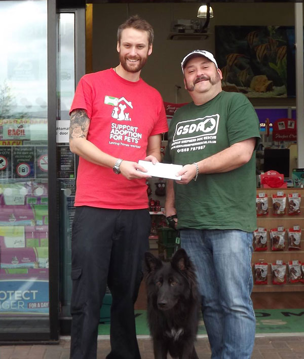 pets at home employee presenting a cheque to GSDR volunteer