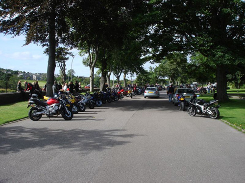 motor bikes all parked neatly in a row