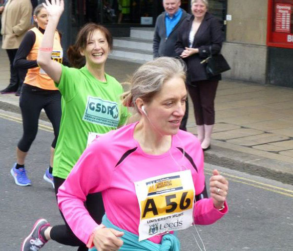 volunteer running and waving